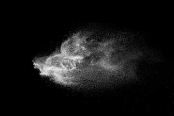 Wall Mural - freeze motion of white color powder exploding on dark background.