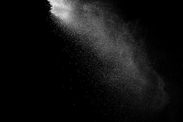 Wall Mural - freeze motion of white color powder exploding on dark background.