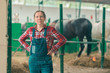 Portrait of female rancher at horse stable looking at camera