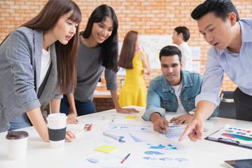 Wall Mural - creative asian agency business brain storm meeting presentation team discussing roadmap to product l