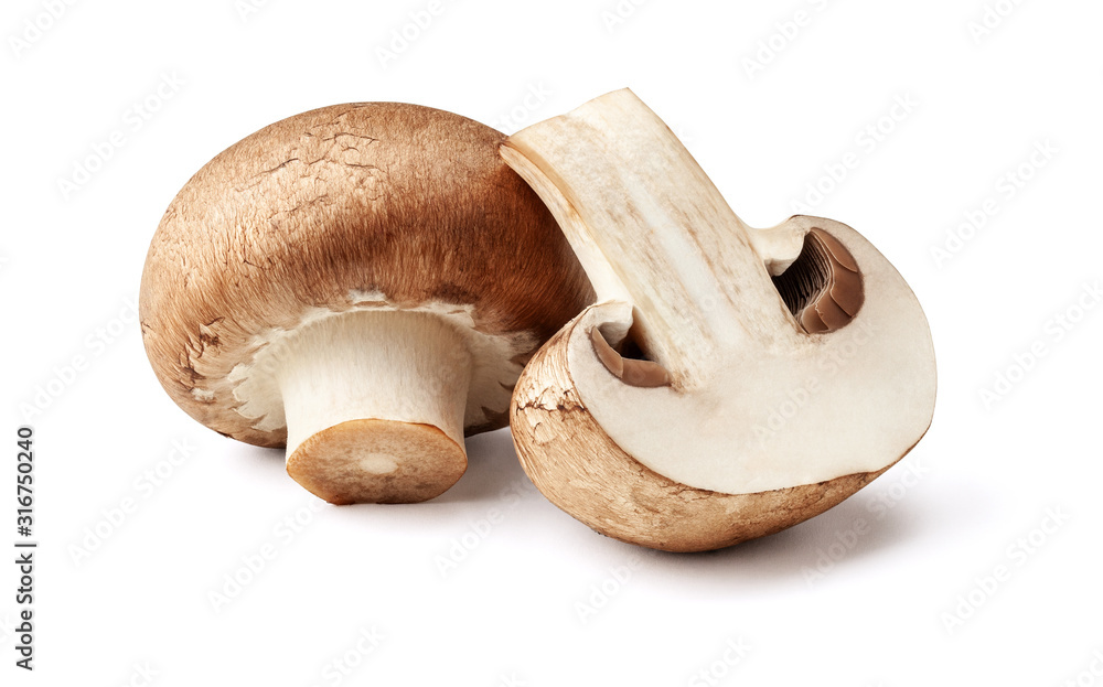 Two fresh mushrooms champignons, one whole and the other cut in half isolated on white background with clipping path - obrazy, fototapety, plakaty 