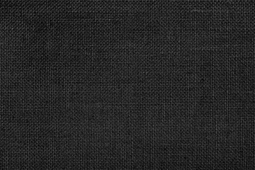 Wall Mural - Close-up texture of natural weave cloth in dark and black color. Fabric texture of natural cotton or linen textile material. Black fabric background.