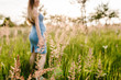 © Serhii - Grass in outdoor on back background pregnant happy girl stand and poses, in field in sunlight. half length, upper half. Close up.