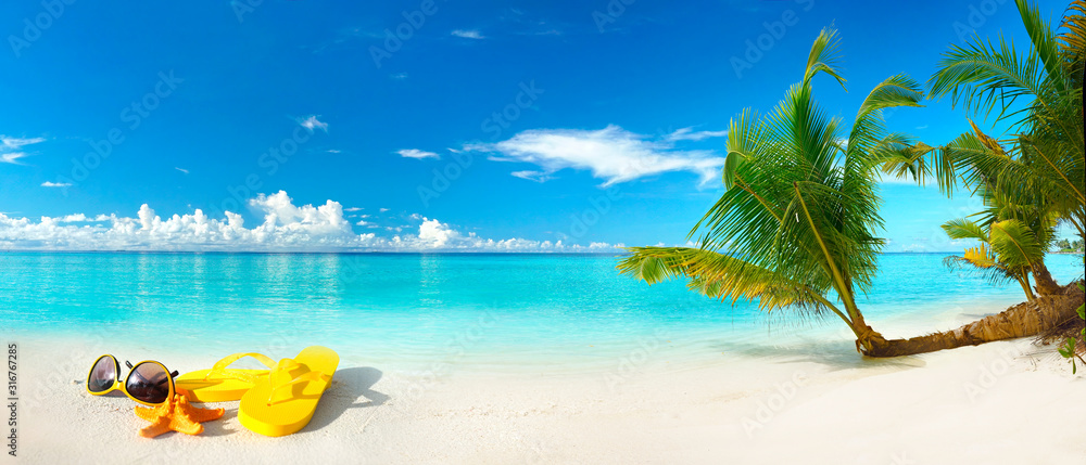 White sand beach, turquoise ocean, blue sky, clouds, palm tree over water, sunglasses, flip-flops and starfish. Maldives, perfect tropical landscape, ultra wide format, concept of summer vacation. - obrazy, fototapety, plakaty 