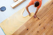 © karepa - Craftsman is laying parquet flooring in a modern new building