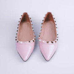 Wall Mural - Female pink shoes on gray background