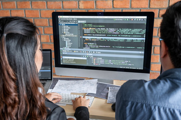 Wall Mural - programmers cooperating at developing programming and website working in a software develop company 