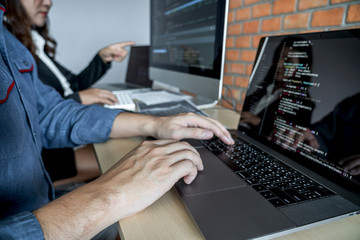 Wall Mural - programmers cooperating at developing programming and website working in a software develop company 