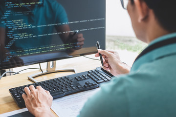 young professional programmer working at developing programming and website working in a software de