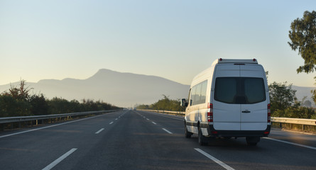 sightseeing minibus performing transfer tourists to natural parkland
