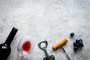 Wall Mural - bottle of red wine and corkscrew on stone background top view mockup