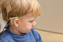 Boy With A Hearing Aids And Cochlear Implants