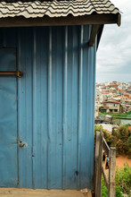 Blue Colorful Facade Of Humbre House In Antananarivo Suburb Surrounded By Rice Fields And Hills On Cloudy Day, Madagascar