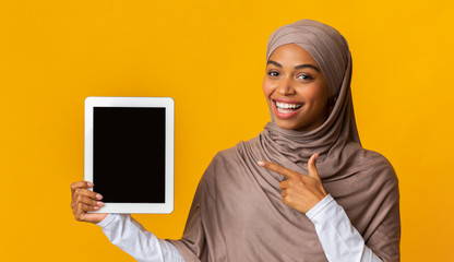 Wall Mural - Black Muslim Woman Pointing At Digital Tablet With Black Screen