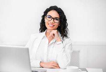 Mexican recruiter looking at camera with hand on chin