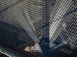 Galvanized grating for movement on a gantry crane on a sunny day.