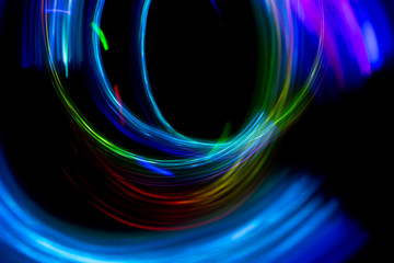 Wall Mural - Abstract color pattern of luminous stripes on a black background, bright and smooth color streaks