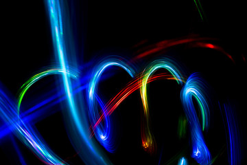Wall Mural - Abstract color pattern of luminous stripes on a black background, bright and smooth color streaks