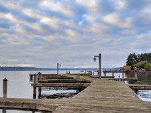 Boat Dock Path Leading Out Into Lake Washington, The Seattle Cityscape In The Background