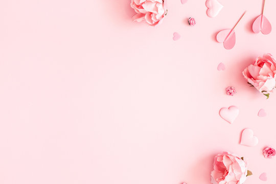 valentine's day background. pink flowers, envelope, hearts on pastel pink background. valentines day