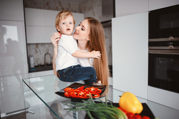 Family in a kitchen. Beautiful mother with little son