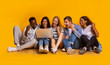 © Prostock-studio - Group of students checking exam results online over yellow background