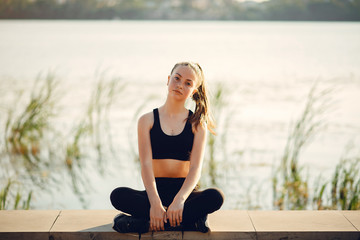 Sports girl. Woman in a summer park. Lady in a sports wear