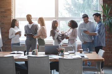 Wall Mural - Friendly business team talking while having break