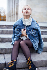 young pretty teenage girl posing cheerful happy smiling wearing street style outside in europe city, lifestyle people concept