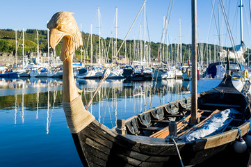 Wall Mural - Traditional viking's drakkar at Tarbert marina. Hebrides, Scotland.