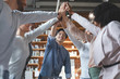 © Prostock-studio - Multiracial young team giving high five in office