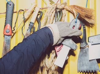 Wall Mural - A set of tools on a yellow wall. Concept of work in a home workshop, doing homework. Tools such as the grinding wheel, saw hang on the wall.