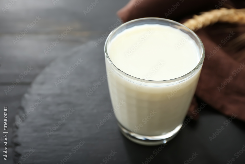 Glass of tasty on dark table