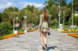 © Andrey_Arkusha - Young beautiful woman in green dress walking on the summer street