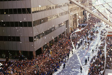 City Street Corner With Parade And Crowd