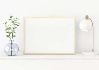 Aufkleber - Interior poster mockup with horizontal gold metal frame on the table with plant in blue vase and lamp on empty white wall background. A4, A3 size format. 3D rendering, illustration.