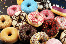 Assorted Donuts With Chocolate Frosted, Pink Glazed And Sprinkles Donuts