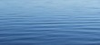 Calm surface of light blue water as a background