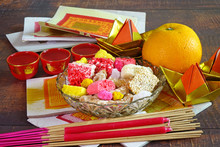 Set Of Colorful Snack, Mandarin Orange, Tea, Candle, Incense Stick And Joss Money Paper For Worship To Taoism Gods / Goddess And Ancestors In Chinese Cultures In All Chinese Festival. Selective Focus