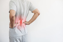 Office Syndrome, Backache And Lower Back Pain Concept. A Man Touching His Lower Back At Pain Point