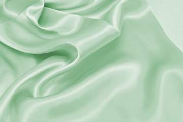 Wall Mural - Draped satin green fabric for festive backgrounds
