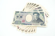 Close up of variety of Japanese yen currency banknotes lay flat and isolate on white background with copy space.