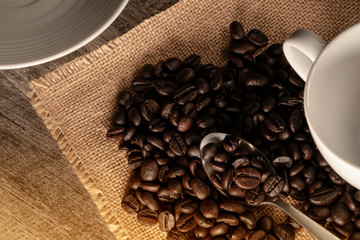 Wall Mural - roast coffee beans and a set of white coffee cup on a retro hemp sack