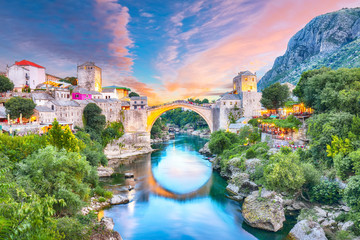 Majestic evening view of Mostar with the Mostar Bridge, houses and minarets, at evening