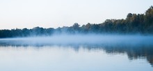 Wide Shot Of A Beautiful Lake With A Light Fog Forming Above It