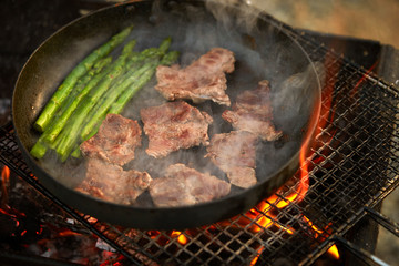 Poster - Cooking beef with asparagus on frying pan 