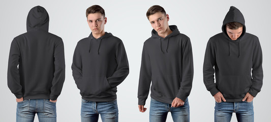 Wall Mural - Mockup black blank hoodie on a young guy for design presentation.