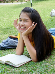 Young woman reading book in the park