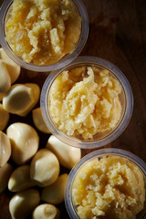 Canvas Print - Crushed garlic in plastic bowl 