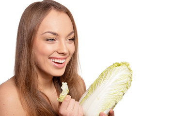 Portrait of a beautiful young woman with cabbages